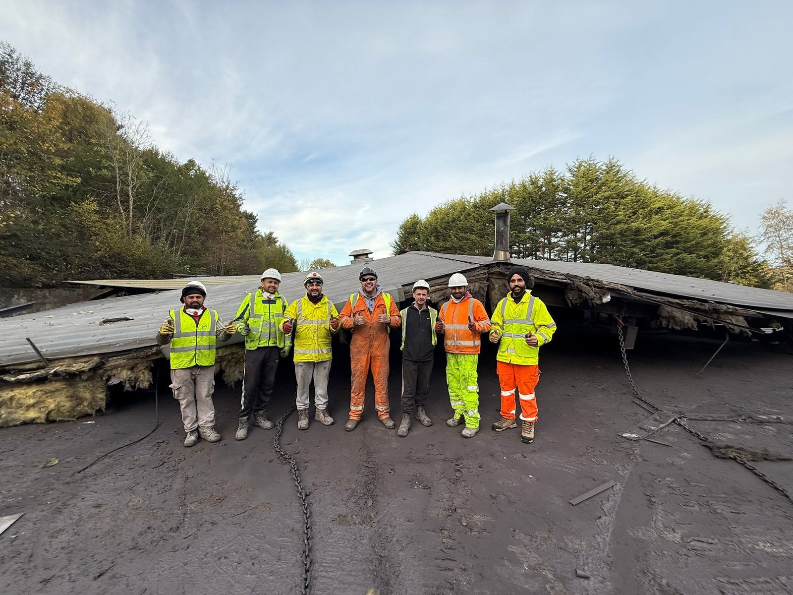 JSR Contracts Limited team members in PPE giving a thumbs up on a soft strip demolition site