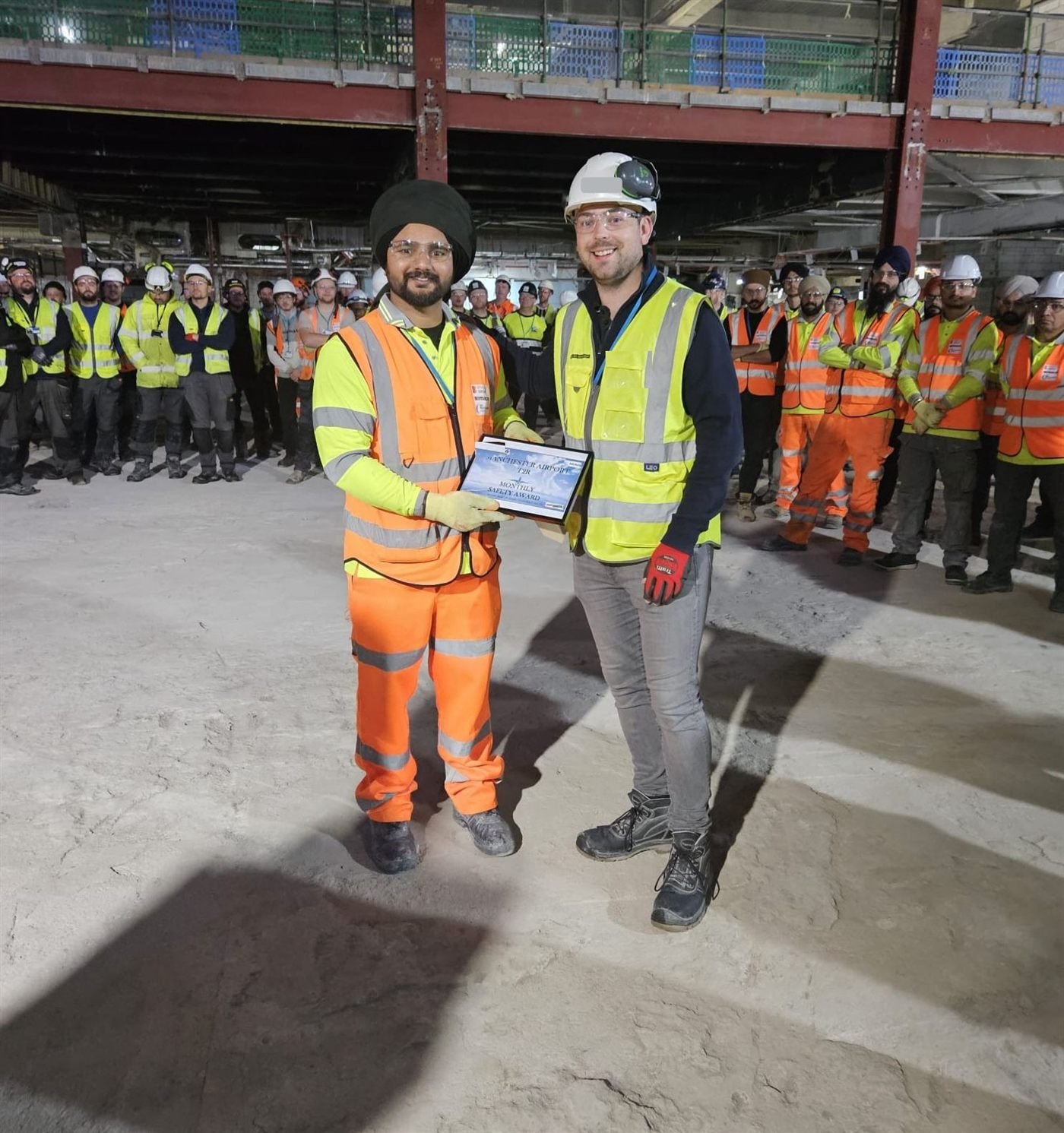 JSR Contracts Limited team receiving a monthly safety award on the Manchester Airport Terminal 2 project
