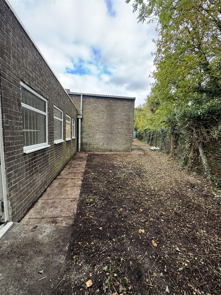Exterior soft strip site — cleared external area alongside the building